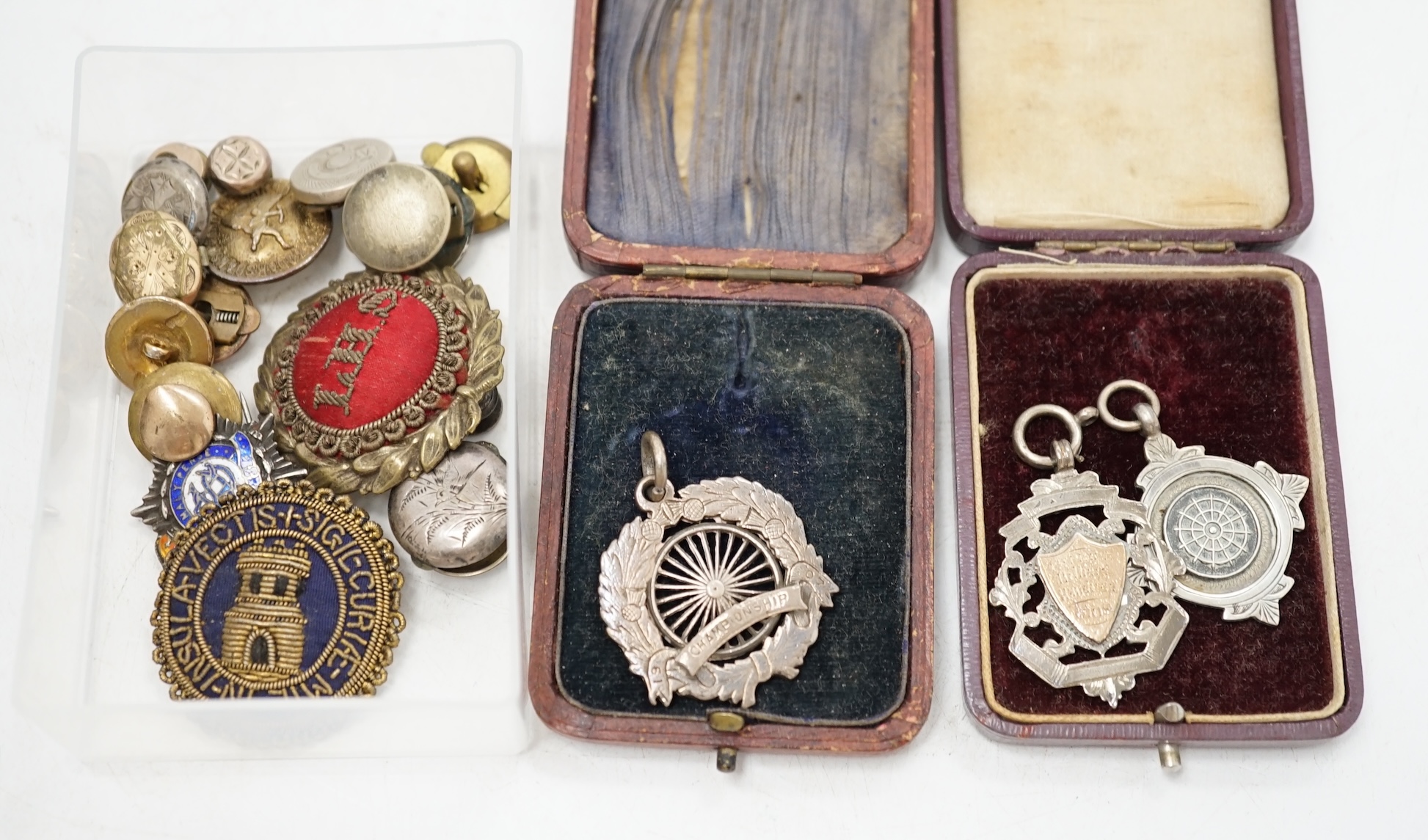 A group of silver and other medals and buttons. Condition - fair